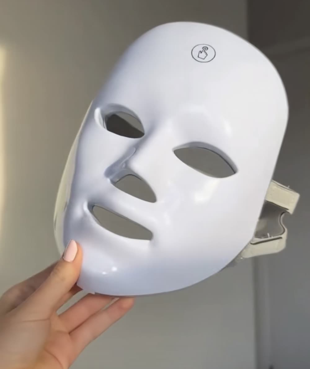 Beyond Skin LED light therapy mask held up, front view
